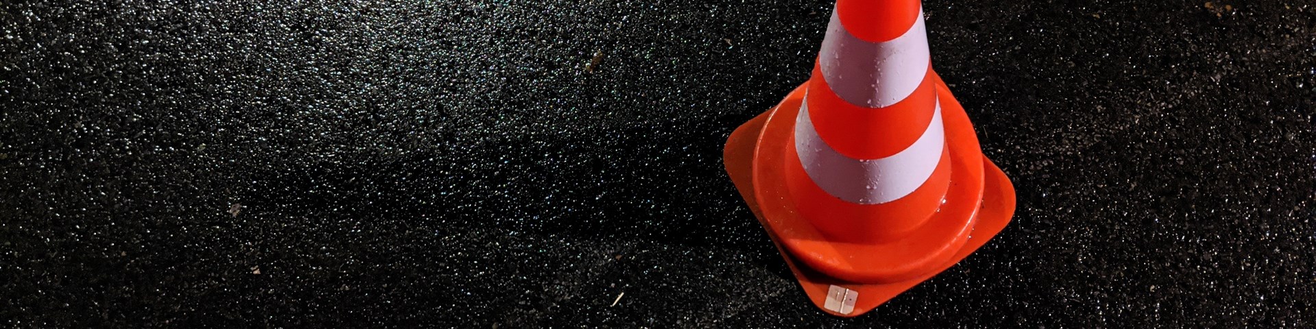 A red traffic cone on a road