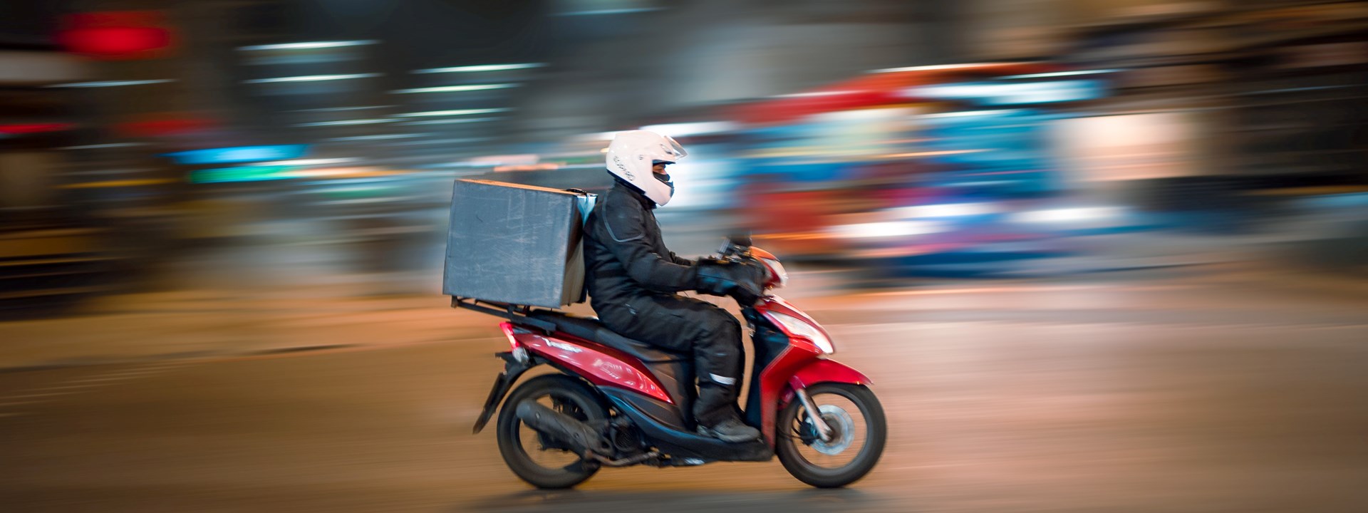 a motorbike delivery driver on the road