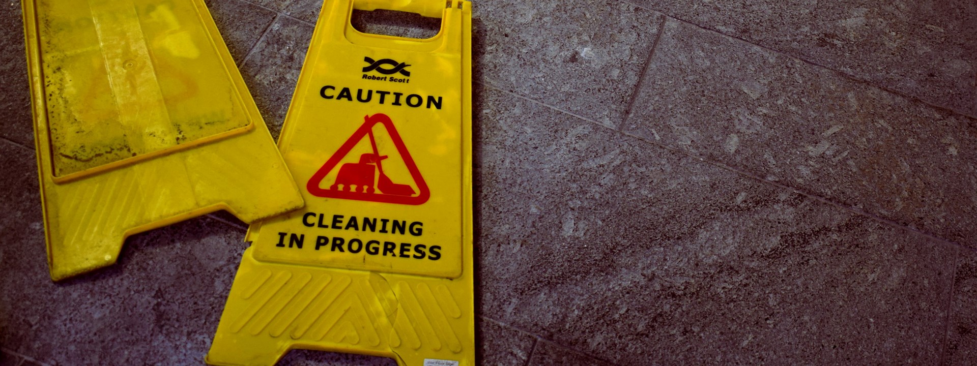 a cleaning sign lying on the floor of a business