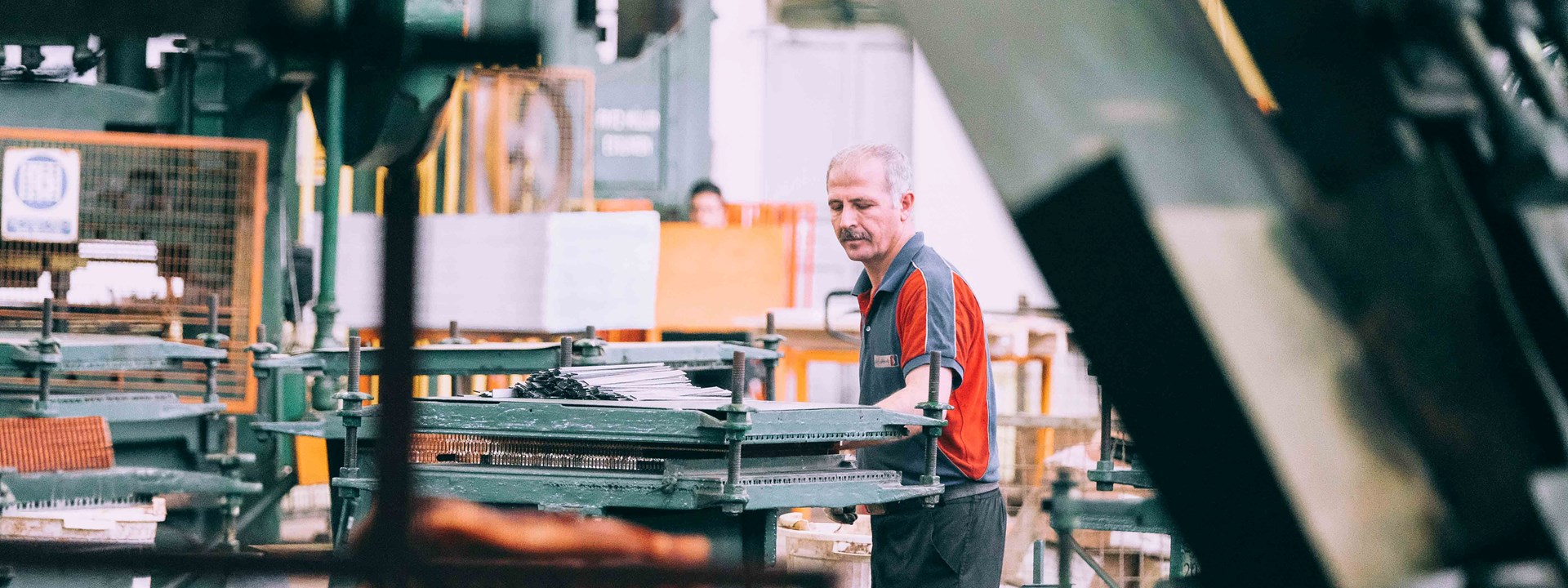 a man working in a sheet metal factory